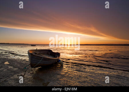 Harty Ferry, Kent, UK. 30 mars 2015. Météo France : une superbe bougie comme une bande de nuages en rouleau au lever du soleil sur un bateau à rames à l'ancien Harty Ferry Crossing sur la rive de l'estuaire de Swale près de Oare, dans le Kent. Soleil et gratuites va dominer le début du printemps météo pour les prochains jours Banque D'Images