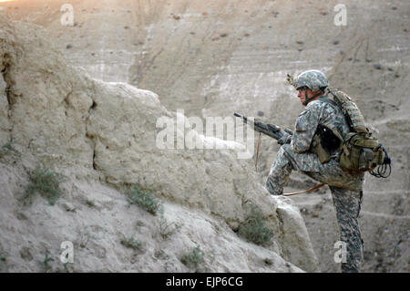 Le sergent de l'armée américaine. Jesse D. Smith, un chef d'équipe au sein du 3e Peloton, C Troop, 1er escadron, le 172e régiment de cavalerie, 86th Infantry Brigade Combat Team, donne sur un ravin dans un district Koh-e Safi village ici le 8 septembre. Smith, un Essex Junction, Vermont), indigène, assisté et conseillé des militaires de l'Armée nationale afghane lors d'une agression de l'air de perturber les activités des insurgés. L'ANA, qui a mené l'opération de recherche dans le village, est l'augmentation de leur présence tout au long de la province de Parwan de sécurité comme l'approche des élections du 18 septembre. Banque D'Images