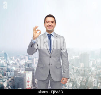 Happy businessman in suit showing ok part sign Banque D'Images