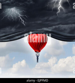 Perspectives positives et de récupération concept comme une personne ou d'un businessman riding red hot air balloon levage de la tempête sombre dangereuses Banque D'Images