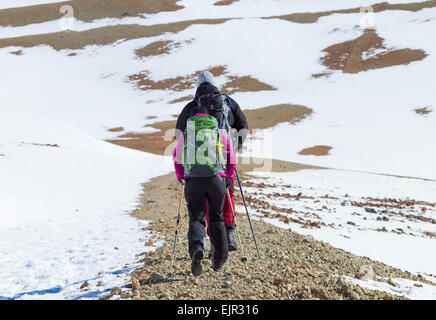 L'homme et de la femme marchant dans la neige a couvert le Parc National du Teide sur Tenerife, Canaries, Espagne Banque D'Images