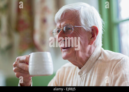 Older Caucasian man drinking coffee Banque D'Images