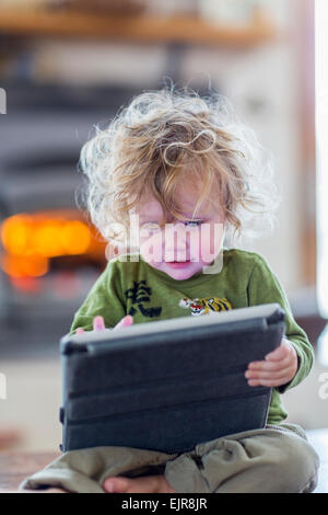 Caucasian baby boy using digital tablet Banque D'Images