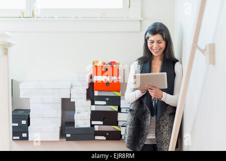 Hispanic woman using digital tablet in office Banque D'Images