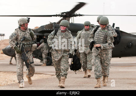 Le Commandement de l'armée américaine le Sgt. Le major Lawrence Wilson, à gauche, accompagne le sergent de l'armée. 1re classe Mike Schlitz, un guerrier blessé revenant à l'Iraq dans le cadre de l'opération de sortie appropriée, sur Camp Ramadi, l'Iraq, le 29 décembre 2009. Le programme retourne aux anciens combattants gravement blessés à la bataille où ils ont été blessés, afin de les aider à trouver la fermeture psychologique. La CPS de l'armée américaine. Michael J. MacLeod Banque D'Images