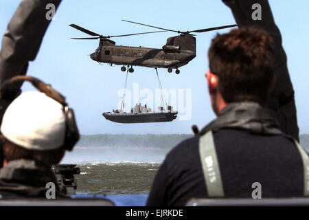 Des opérations spéciales de la Marine américaine-combattant de l'équipage d'artisanat SWCC à bord d'un canot pneumatique à coque rigide observer un hélicoptère CH-47 Chinook de l'armée affectés à la 159e Régiment d'aviation qu'il soulève un autre canot au cours d'un système de transport maritime de l'air externe Formation des viandes de l'exercice dans la Virginia Capes près de Fort Eustis, en Virginie, le 16 juillet 2008 membres de trains VIANDES SWCC sur l'extension de leur portée opérationnelle en attachant de l'artisanat opérations spéciales à des hélicoptères pour le transport vers des sites distants pour poursuivre leur formation. Spécialiste de la communication de masse 3 Classe Robyn Gerstenslager Banque D'Images