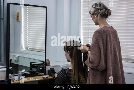 Style coiffure Femme les cheveux d'un modèle féminin dans un salon de prêt pour une vitrine de la mode. Banque D'Images