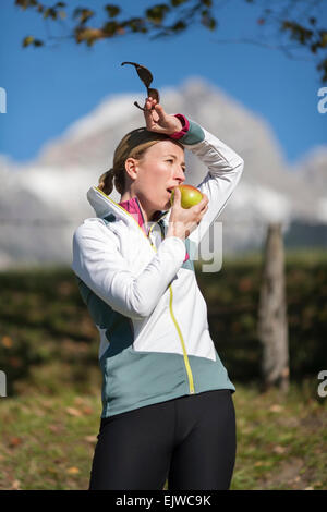 L'Autriche, Salzburger Land, Maria Alm, Woman eating apple Banque D'Images