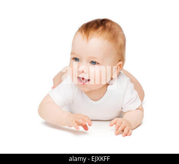 Smiling baby lying on floor Banque D'Images