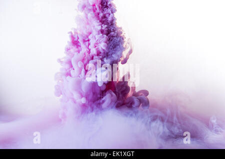 Encre de couleur violet créer des modèles de fumée dans l'eau Banque D'Images