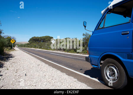 Camping-bleu van roulant le long de la route en Australie. Banque D'Images