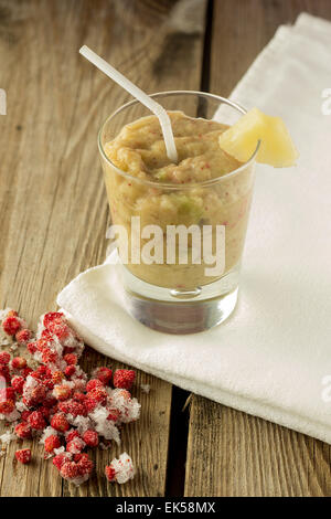 Tiré de la banane et aux fruits rouges smoothie céleri sur vertical table en bois Banque D'Images