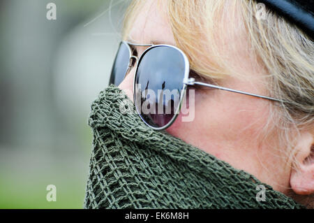 Une femme portant un scrim masqué sur sa bouche, lunettes de soleil et un béret noir fait partie d'une commémoration Républicaine Irlandaise Banque D'Images