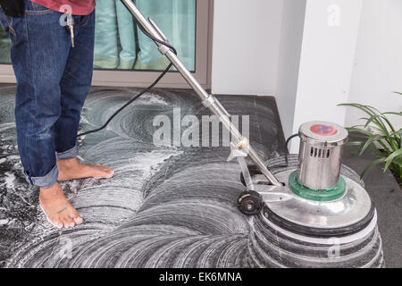 Les thaïlandais avec un sol en granit noir de nettoyage chimique et de la machine Banque D'Images