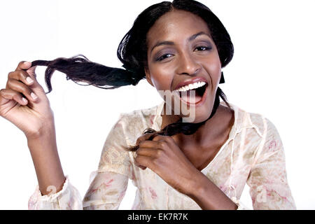 Modèle féminin sombre jouant avec ses cheveux Banque D'Images