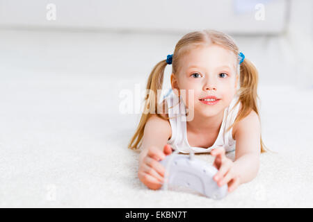 Fille jouant sur une console de jeu Banque D'Images