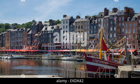 Bateaux amarrés au quai du port à côté de bâtiments historiques, cafés et restaurants, la ville de Honfleur, Normandie France Banque D'Images