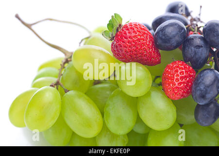 Tas de raisins blancs et noirs et les fraises isolé sur whi Banque D'Images