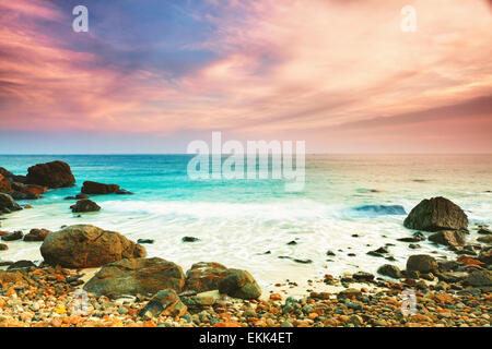 Le lever du soleil sur la mer. Pierre sur l'avant-plan Banque D'Images