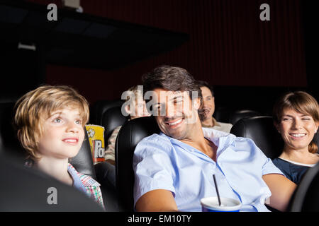 Happy Family watching movie in theatre Banque D'Images