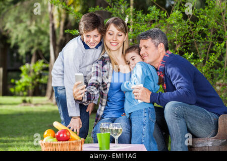 Prendre la famille autoportrait par smartphone en camping Banque D'Images