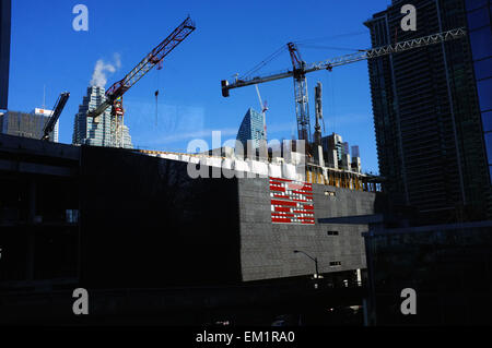 Des grues à tour entouré de gratte-ciel dans le centre de Toronto au Canada. Banque D'Images