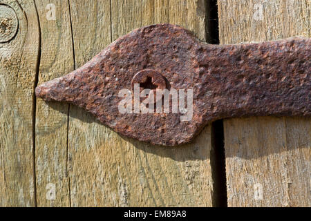 Charnière rouillée sur la vieille porte de grange en bois Banque D'Images