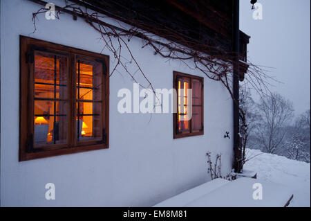 Windows illuminé d'alpine house en soirée d'hiver Banque D'Images