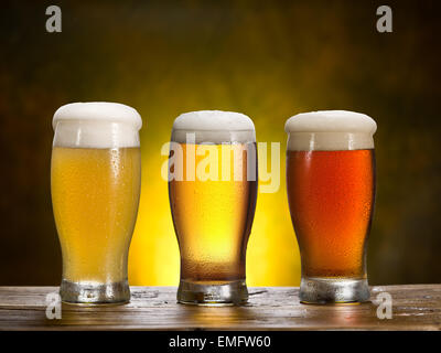 Trois verres de bière sur une table en bois. Banque D'Images