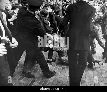 Grande foule rassemblée dans Ridley Road E8 pour manifester contre l'ancien leader fasciste Sir Oswald Mosley et les membres de son groupe Blackshirt antisémite qui avait prévu un rassemblement à l'East End londonien. Mosley et son Blackshirt antisémites ont été agressés et de poing au sol dès que sa réunion est ouverte au Ridley Road, Dalston. La clôture de la réunion de la police dans les trois premières minutes et a fait 54 arrestations l'un des arrêtés était le fils de Sir Oswald Max. 2 Août 1962 Notre photo montre : Sir Oswald Mosley étant jeté à terre Banque D'Images