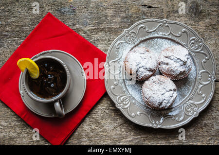 Muffins au chocolat et une tasse de thé sur le fond en bois Banque D'Images