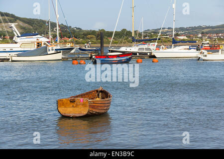 L'Aviron bateau amarré près du rivage de l'estuaire de la rivière Conwy, Conwy, au nord du Pays de Galles, avec une variété de bateaux et yachts ancrés dans la mi-fleuve. Banque D'Images