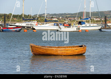 L'Aviron bateau amarré près du rivage de l'estuaire de la rivière Conwy, Conwy, au nord du Pays de Galles, avec une variété de bateaux et yachts ancrés dans la mi-fleuve. Banque D'Images