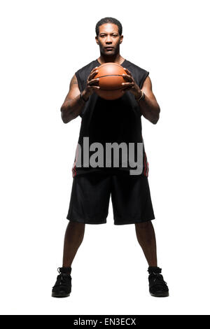 Mid adult man holding basketball Banque D'Images