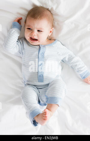 Baby Boy lying on a bed Banque D'Images