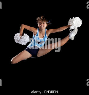 Studio shot of cheerleader (16-17) jumping Banque D'Images