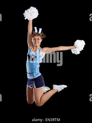 Studio shot of cheerleader (16-17) jumping Banque D'Images