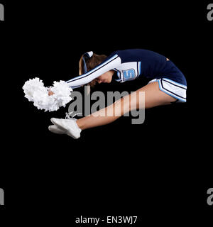 Portrait of teenage cheerleader girl (16-17) jumping Banque D'Images