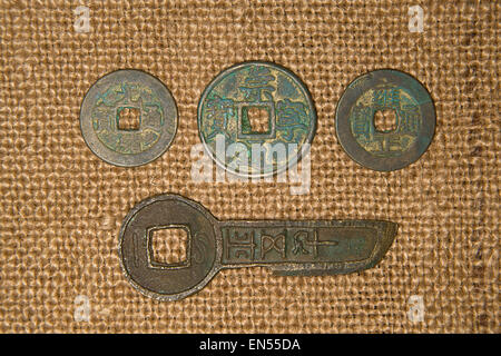 De nombreuses pièces de monnaie chinoise antique bronze sur vieux tissu Banque D'Images