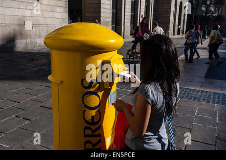 Fille déposant une lettre dans une boîte aux lettres, boîte aux lettres, Buzón de correos, Barcelone, Catalogne,Espagne Banque D'Images