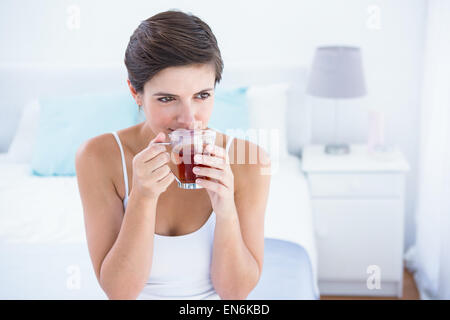 Thoughtful woman drinking cup of tea Banque D'Images