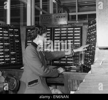 Photo pour accompagner la révolution 'Robot' qui s'est déroulé dans le journal Daily Mirror sur la semaine commençant le 27 juin 1955. Photo montre : un travailleur se trouve à l'un des panneaux de la salle de commande du convoyeur central lors de l'enroulement du moteur d'usine Brook M Banque D'Images