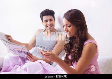 Femme lisant un sms sur un téléphone mobile Banque D'Images