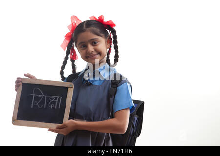 Portrait of school girl holding slate Banque D'Images