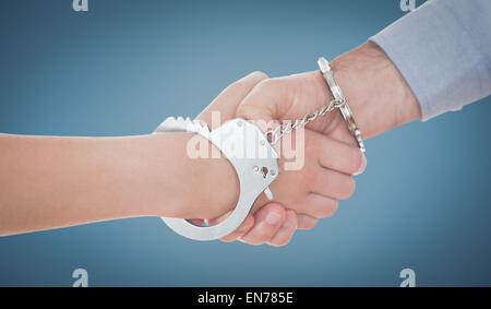 Image composite de menotté business people shaking hands Banque D'Images