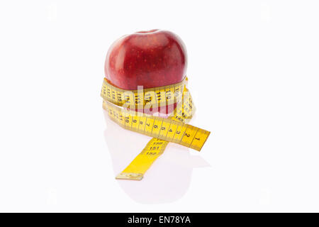 Pomme rouge enveloppé de ruban à mesurer Banque D'Images