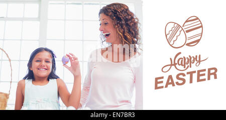 Image composite de happy girl holding easter egg Banque D'Images