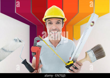 Image composite de portrait of happy worker holding divers équipements Banque D'Images