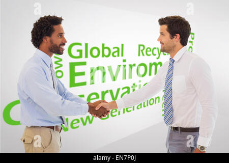 Portrait of young businessmen shaking hands in office Banque D'Images