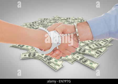 Image composite de menotté business people shaking hands Banque D'Images